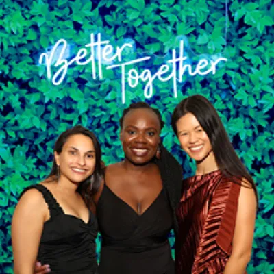 Neon sign hung on photo booth backdrop